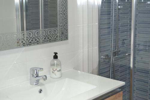 a white bathroom with a sink and a shower at Primera línea playa in Roquetas de Mar