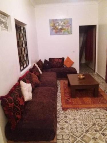 a living room with a couch and a table at Atlas Resorts in Aït Ourir