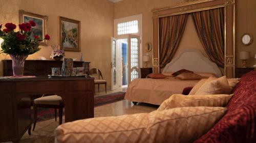 a hotel room with a bed and a desk and a couch at B&B Beroni a Venezia in Venice