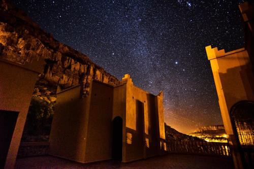 a building with a starry sky in the background at Maison D'hotes Sahara in Aoufous