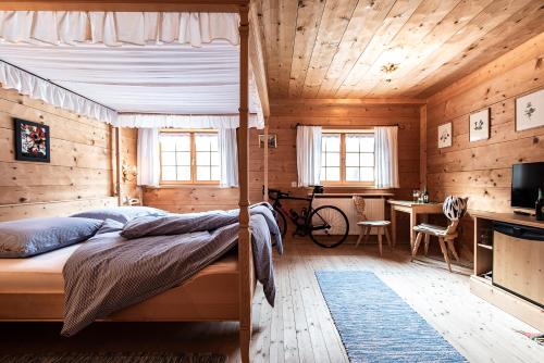 a bedroom with a bed in a wooden cabin at Gämsle Hotel, Wirtshaus & mehr in Schoppernau
