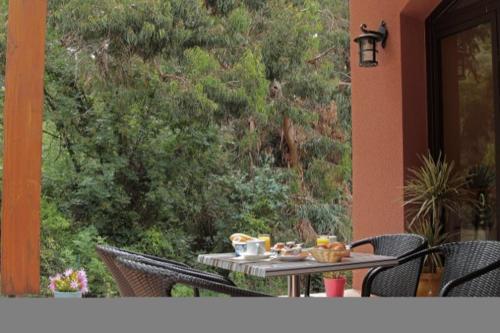 a table with food on it on a patio at Hotel Corsica - Porto Corse in Porto Ota