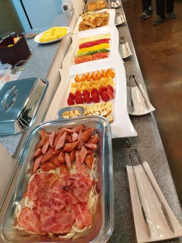 a buffet with several trays of food on a table at The Beauty Hotel in Gangneung