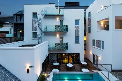 an external view of a building with a swimming pool at Hotel The Royal Snail in Namur