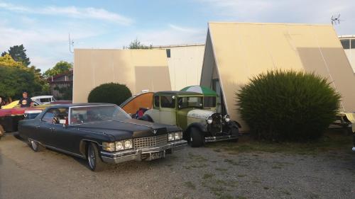 an old car is parked next to a truck at Rangiora Eco Holiday Park in Fernside