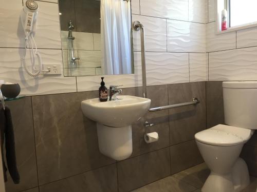 a bathroom with a sink and a toilet at BigSky Motels in Omarama