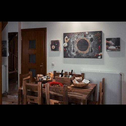 a dining room with a wooden table and chairs at Villa Agno - Βίλα Αγνώ in Ãno KariaÃ­