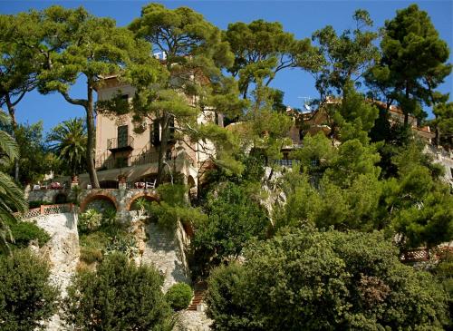 a house on the side of a mountain at Hotel Punta Est in Finale Ligure