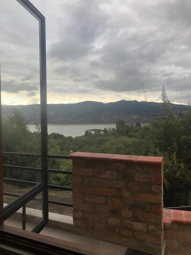 a balcony with a view of a river and mountains at APTO 102 EN "ABADIA de TOMINE" in Guatavita