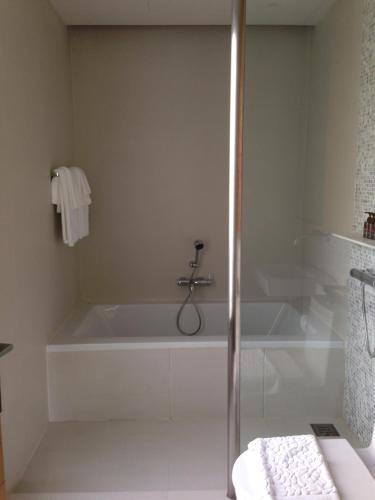 a white bath tub in a bathroom with a shower at My sweet home@ChiangMai in Ban Dong