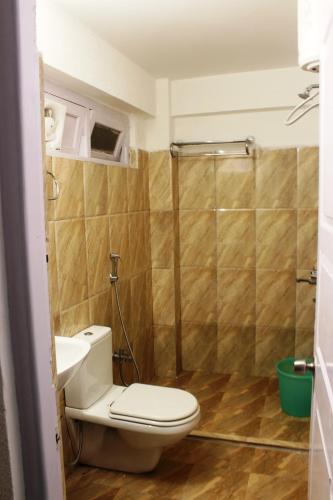 a bathroom with a toilet and a shower at Hotel Paradiso in Kalimpong