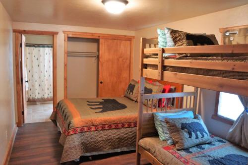 a bedroom with two bunk beds and a window at Blue Horizon Lodge in Big Bear Lake