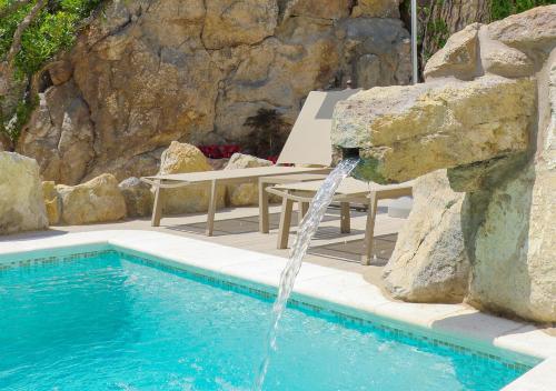 a swimming pool with a water fountain at Villa Caruso in Ischia