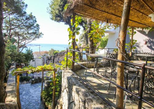 a balcony of a restaurant with a view of the ocean at Villa Caruso in Ischia