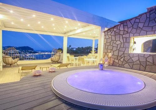 a large hot tub on the deck of a house at Villa Caruso in Ischia