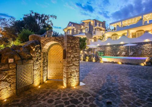 a large house with a stone wall and a gate at Villa Caruso in Ischia