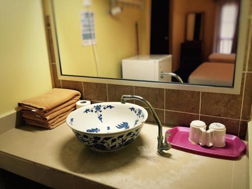 a bathroom counter with a sink and a mirror at Redang Bay Resort in Redang Island