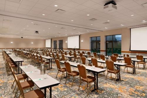 an empty banquet hall with tables and chairs at Wyndham Garden State College in State College
