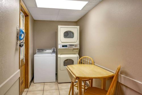 a small room with a table and a washer and dryer at Super 8 by Wyndham Cortez/Mesa Verde Area in Cortez