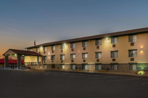 a large building with a parking lot in front of it at Super 8 by Wyndham Cortez/Mesa Verde Area in Cortez