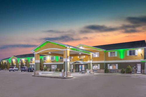 a hotel with a parking lot in front of it at Super 8 by Wyndham Bedford in Bedford