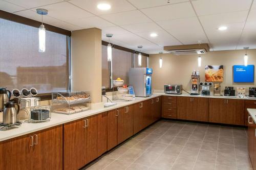 a large kitchen with wooden cabinets and a cafeteria at Comfort Inn & Suites At Copeland Tower in Metairie