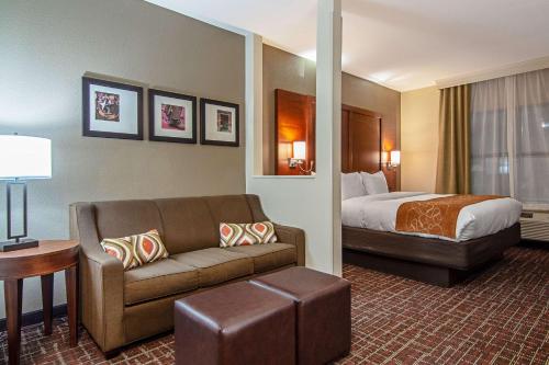 a hotel room with a bed and a couch at Comfort Suites NW Dallas Near Love Field in Dallas