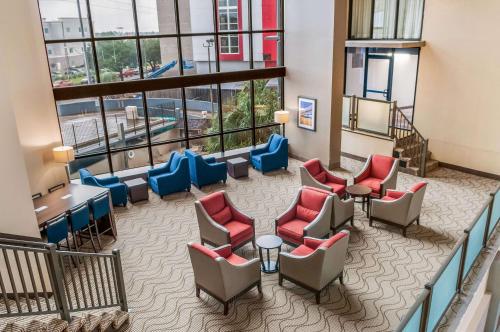 a lobby with chairs and tables in a building at Comfort Inn & Suites At Copeland Tower in Metairie