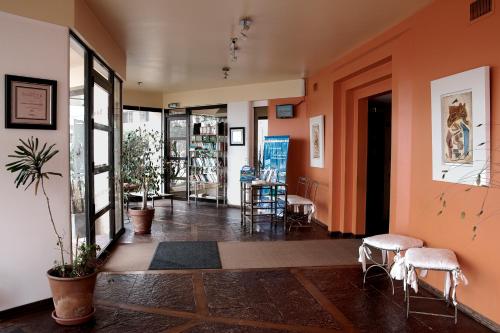 a hallway with chairs and tables in a building at Club Sol Mar Del Plata in Mar del Plata