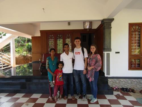 a family poses in front of a house at EAST STAVANGER in Anaviratty