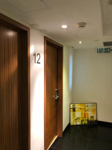 a door in a room with a sign on the wall at Homy Residence in Hong Kong