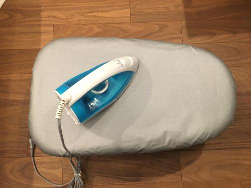a white and blue phone sitting on top of a pillow at Hotel Yuzuki in Takamatsu