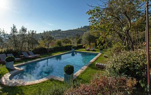 a swimming pool in the yard of a house at Villa Bordoni in Greve in Chianti