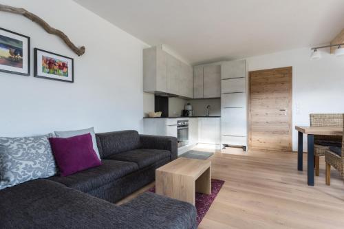 a living room with a couch and a table at Haus am Stein in Oetz