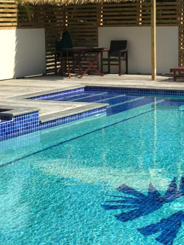 a large swimming pool with blue water at Serenity Villas Rarotonga in Rarotonga