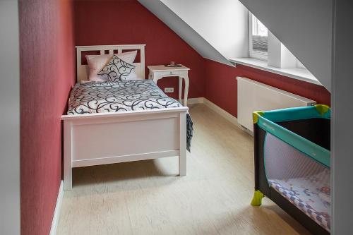 a small room with a bed and a staircase at Haus Hotel & Pension Villa Laluna in Blankenburg
