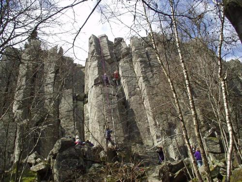 people climbing on a rock face in the forest at Gästehaus Klein in Hilders