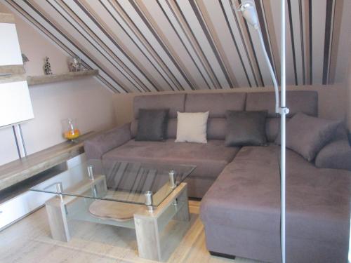 a living room with a couch and a table at Gästehaus Klein in Hilders