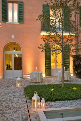 a courtyard with tables and lights in front of a building at Le Case Di San Vitale in Ravenna