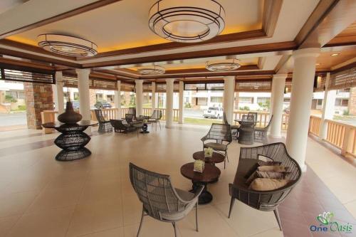 a lobby with chairs and tables in a building at Alles One Oasis Condo Davao Near SM Mall with Wifi in Davao City