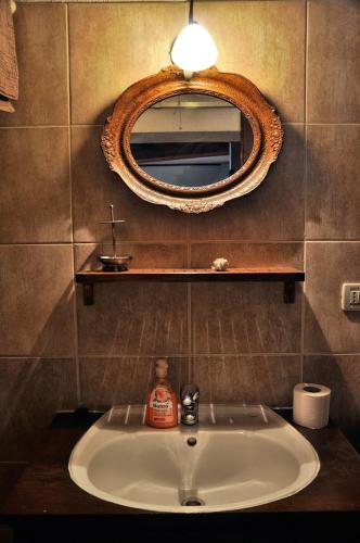 a bathroom with a sink and a mirror on the wall at Tvrdic Honey in Grohote