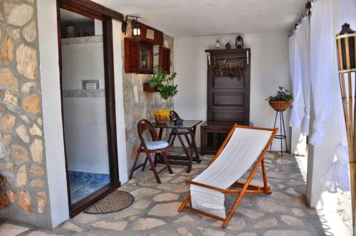 a room with a table and chairs and a mirror at Tvrdic Honey in Grohote