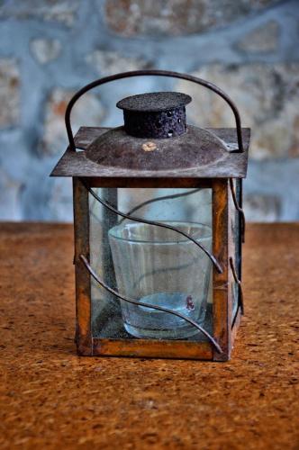 a glass lantern with a cup inside of it at Tvrdic Honey in Grohote