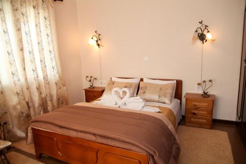 a bedroom with a bed with two towels on it at The Villa of the Winds in Néa Kíos