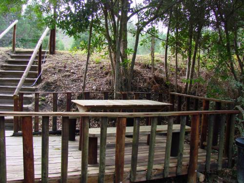a wooden deck with stairs and a table on it at Hindthausen in Knysna