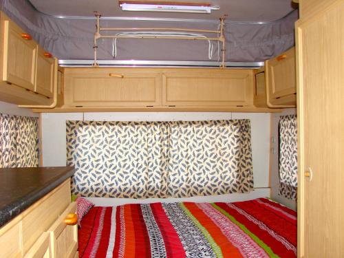 an interior of an rv with a red and white rug at Hindthausen in Knysna