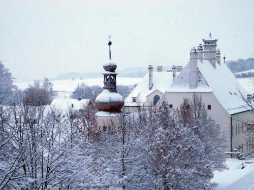 a church covered in snow in front at Schloss Thalheim in Sankt Pölten