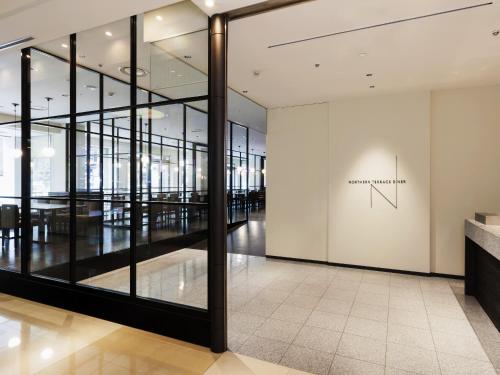 an empty lobby with a large glass wall at Sapporo Grand Hotel in Sapporo