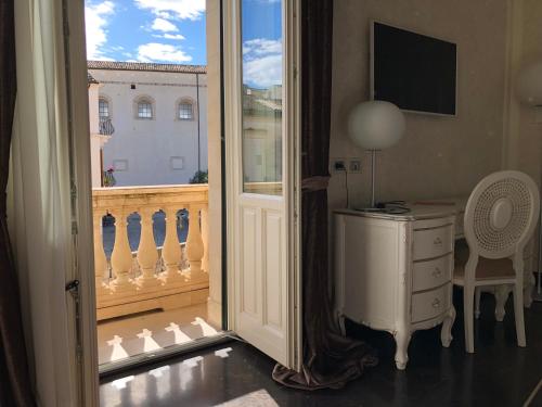 a room with a view of a balcony with a window at Palazzo Favacchio - Patanè in Scicli