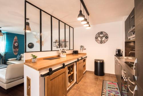 a kitchen with a wooden counter in a room at T4 8 personnes de grand standing classé 4 étoiles en plein centre de Saint Lary Soulan in Saint-Lary-Soulan